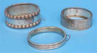 Two silver bangles and another silver coloured bangle.  59.8 grams/1.9 oz