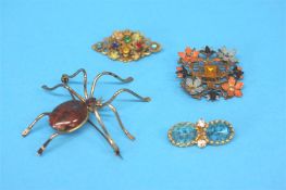 Four decorative costume brooches.