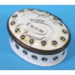 A 19th century oval enamelled trinket box, 'Accept a trifle from a friend'.  5 cm long