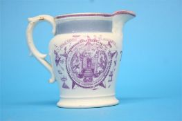 A small Sunderland lustreware masonic cream jug initialled T W.  10 cm long