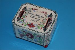 A Victorian Stockton ware money box decorated with flowers and inscribed Elizabeth Jane Murray,