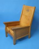 A Robert "Mouseman" Thompson oak Smoker's Chair with slung leather back, leather cushion with carved