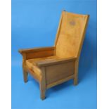 A Robert "Mouseman" Thompson oak Smoker's Chair with slung leather back, leather cushion with carved