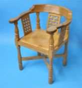 A Robert "Mouseman" Thompson oak monk's chair with carved back and arms, with 3 lattice work panels,