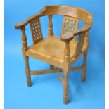 A Robert "Mouseman" Thompson oak monk's chair with carved back and arms, with 3 lattice work panels,
