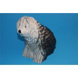 A Beswick figure of a seated Old English Sheepdog, impressed number 453 and printed mark.