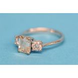 An 18 ct white gold ring, set with a central emerald cut diamond, approx. 1.75 ct and flanked by two