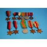 A collection of five Star medals, three 1939-1945, two Africa Stars, a Defence medal and a row of