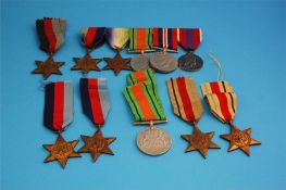 A collection of five Star medals, three 1939-1945, two Africa Stars, a Defence medal and a row of