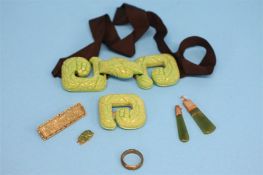 Two jade pendants, a jade ring, a bar brooch and a jade coloured buckle.