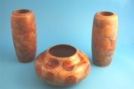 A Royal Doulton stoneware squat shaped bowl decorated with autumnal leaves and a pair of vases.