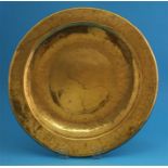 A large brass Alms dish, two pewter plates and a small pewter relief plaque.