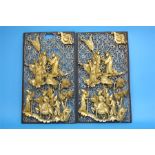 A pair of Chinese pierced fretwork panels each decorated with figures and horses in relief behind an