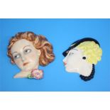 A 1930's continental wall mask of a lady and another with a lady wearing a black hat.  21 cm long