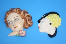 A 1930's continental wall mask of a lady and another with a lady wearing a black hat.  21 cm long