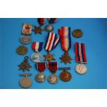 A collection of various unnamed World War I and World War II medals, a World War I Christmas tin