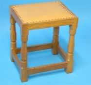 A Robert "Mouseman" Thompson oak rectangular stool with upholstered seat, carved mouse to the leg