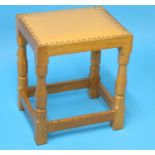 A Robert "Mouseman" Thompson oak rectangular stool with upholstered seat, carved mouse to the leg