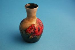 A small Moorcroft vase decorated with "Hibiscus" on mottled green ground, impressed mark.  9 cm