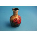 A small Moorcroft vase decorated with "Hibiscus" on mottled green ground, impressed mark.  9 cm