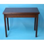 A Georgian mahogany fold over tea table, supported on square champfered legs.  96 cm wide