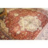 A Tabriz, North West Persian carpet, the madder red ground strewn with naturalistic flowering