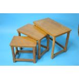 A Robert "Mouseman" Thompson oak nest of three rectangular tables with octagonal legs and a carved