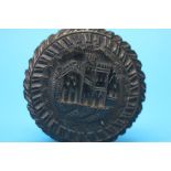 A small ebonised circular box and cover decorated with town scene. 5cm diameter