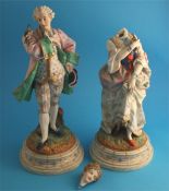 A pair of continental bisque porcelain figures of a gallant and a lady; supported on stepped