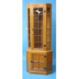 A Robert "Mouseman" Thompson oak standing corner cabinet of canted form, the top with single