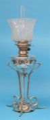 A Hinks silver plated Art Nouveau style oil lamp with frosted shade, below a shaped base,