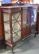 An Edwardian mahogany china cabinet supported on claw and ball feet.  134 cm wide