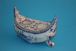 A Dutch Delft blue and white boat shaped inkstand decorated with a windmill and sailing ships