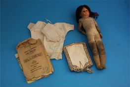 A continental doll with glass eyes and leather clad body, dolls clothes, evening bag etc.