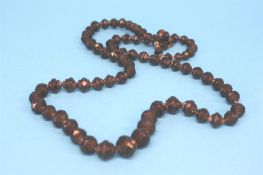 A carved string of jet beads.