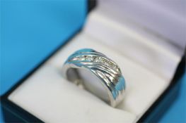 A platinum ring set with a diagonal band of five brilliant cut diamonds, approximately 0.50