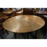 A large oak gateleg dining table.  171 cm extended, 152 cm long