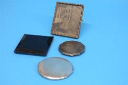 Three silver compacts, five various compacts and a yellow metal photograph frame. (9)