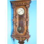 A large walnut cased double weight Vienna regulator clock with cream dial, 8 day movement, second