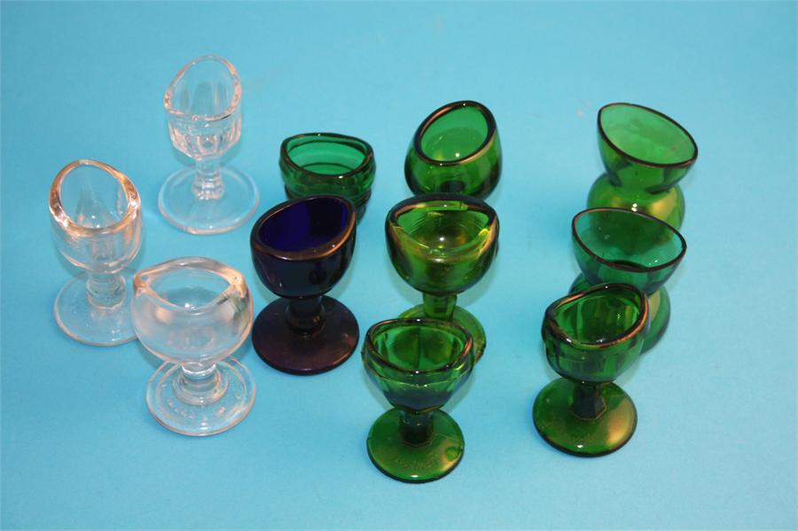 A collection of glass eye baths, seven green, one blue and 3 clear glass. (11)