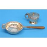 A silver tea strainer, Birmingham 1926 and a silver salt pot.