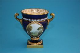 A small Royal Worcester Campagna shaped vase, the front decorated in enamels with a view of