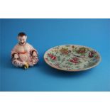 A Chinese Canton enamel circular plate and a porcelain seated Chinese nodding figure.  25 cm