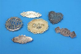 Five Victorian silver name brooches and a carved ivory named brooch. (6)