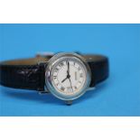A Ladies Gucci Sapphire Crystal wrist watch with white dial, Roman numerals and date aperture,