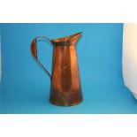 A large copper Arts & Crafts style jug engraved H Barnes, Thornton le Dale, Yorkshire.  42 cm high