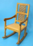 A Robert "Mouseman" Thompson oak rocking chair with a double latticework  back and carved mouse to