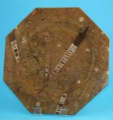 A Hopton Wood limestone octagonal charger with fossilized belemnites and ammonites.  40 cm.