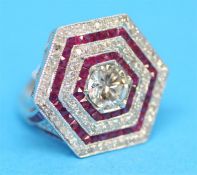 An 18ct white gold diamond and ruby ring, the central diamond approximately 1.06 carats, total