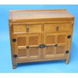 A Robert "Mouseman" Thompson oak batchelor's chest, the fold over top resting on two pull out lobes,